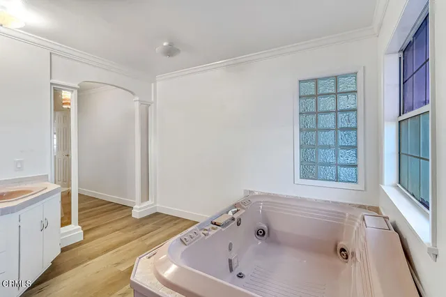 a bathroom with a bathtub and a window