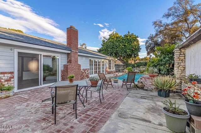 a view of a patio with furniture and potted plants