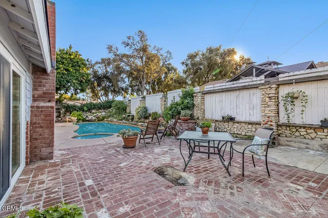 a view of a backyard with sitting area