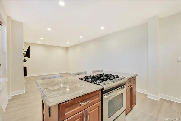 a kitchen with stainless steel appliances granite countertop a stove a sink and a refrigerator