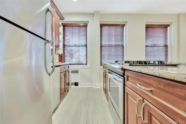 a kitchen with granite countertop a sink and a window
