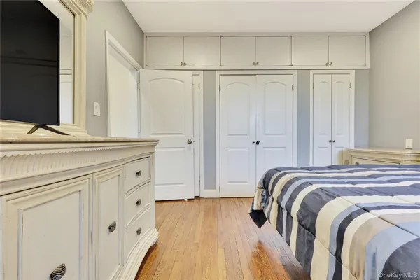 a view of bedroom with wooden floor