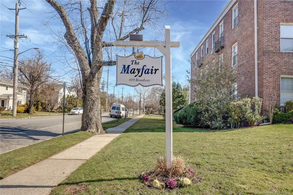 a view of a street with brick building in the background