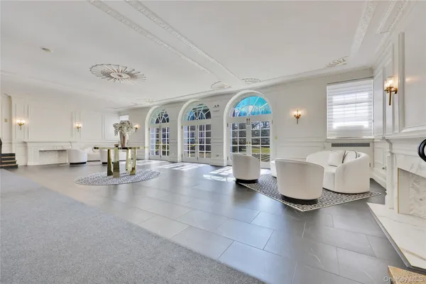 a view of living room filled with furniture and a large window