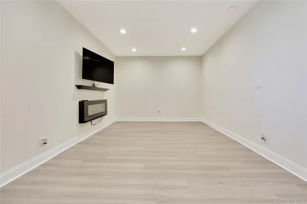 a view of empty room with a flat screen tv