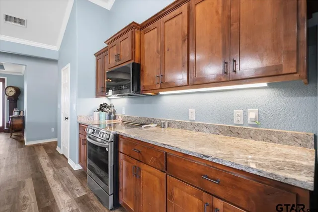 a living room with furniture a fireplace and wooden floor