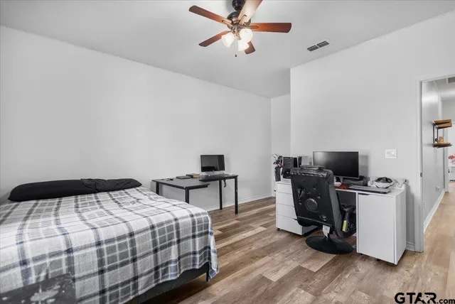 a bedroom with furniture and a window