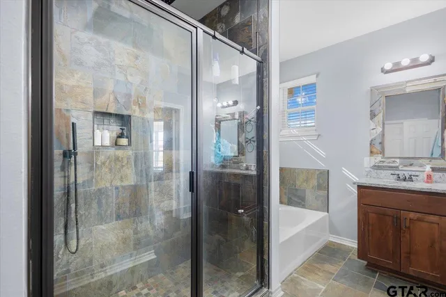 a view of a patio with a table and chairs under an umbrella