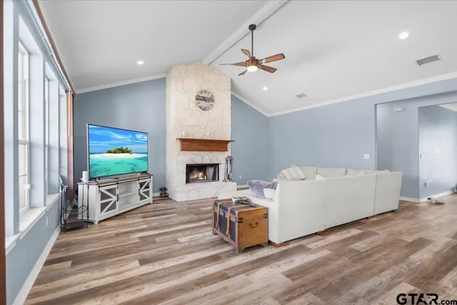 a kitchen with stainless steel appliances granite countertop a stove a sink dishwasher and a refrigerator with wooden floor