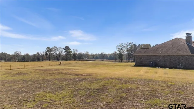a view of a house with swimming pool and sitting area