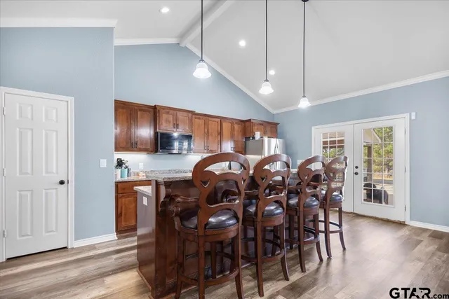 a kitchen with stainless steel appliances granite countertop a sink stove and cabinets