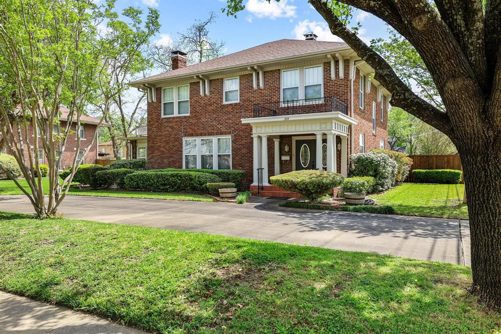 a front view of a house with garden and plants