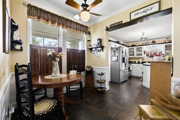 a kitchen with refrigerator and chairs