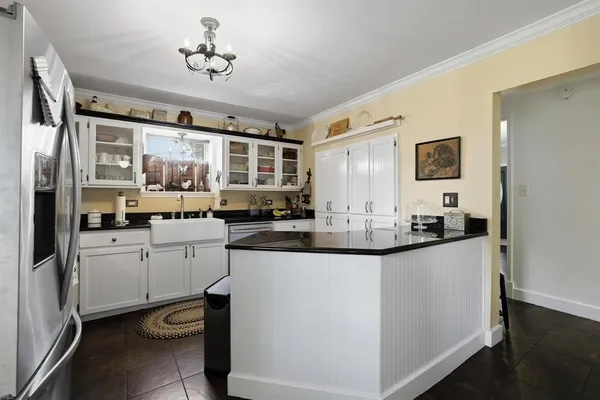 a kitchen with sink cabinets and window