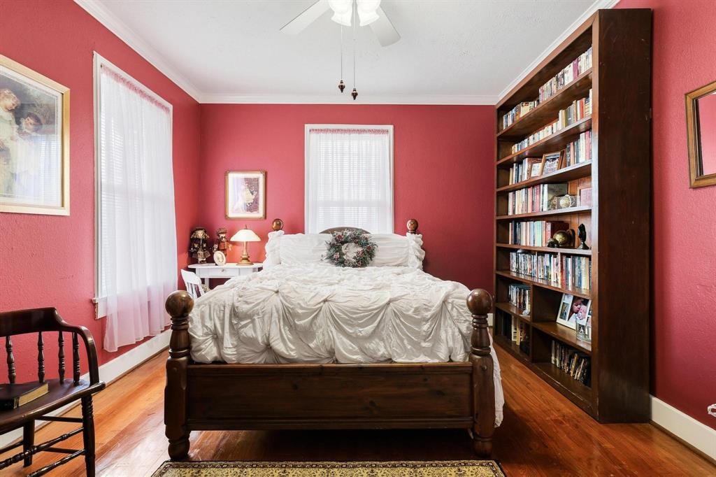 304 East 9th Street Bonham, TX 75418 - Photo 20 of 39 a bedroom with a bed and a bookshelf