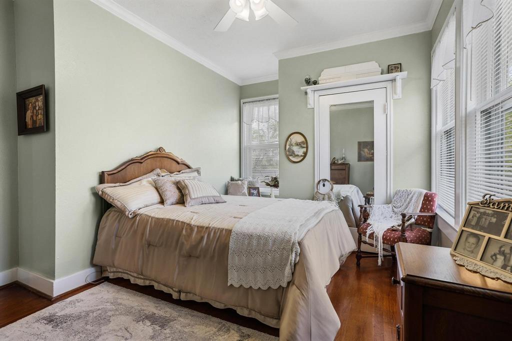 304 East 9th Street Bonham, TX 75418 - Photo 22 of 39 a bedroom with a bed and wooden floor