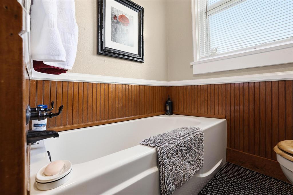 304 East 9th Street Bonham, TX 75418 - Photo 24 of 39 a bathroom with a sink and a bathtub