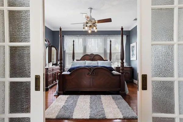 a bed room with a bed mirror and a dresser