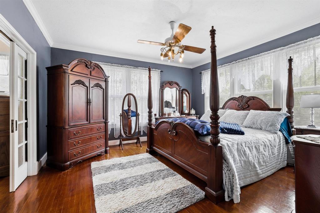304 East 9th Street Bonham, TX 75418 - Photo 30 of 39 a bed room with a bed mirror and a dresser