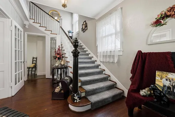 a view of entryway with wooden floor and stairs