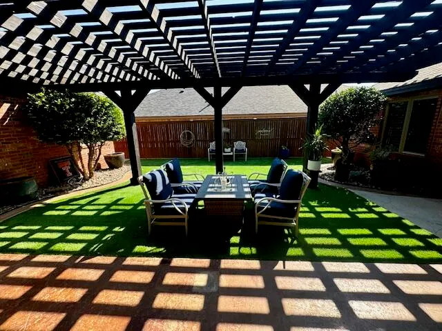 a view of an chairs and table in the patio