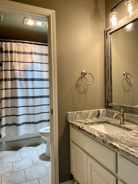 4028 125th Street Lubbock, TX 79423 - Photo 37 of 44 a bathroom with a granite countertop sink and a mirror