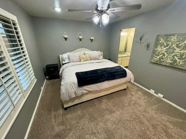 4028 125th Street Lubbock, TX 79423 - Photo 39 of 44 a spacious bedroom with a bed and a chandelier