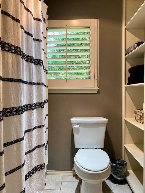 4028 125th Street Lubbock, TX 79423 - Photo 40 of 44 a white toilet sitting next to a window