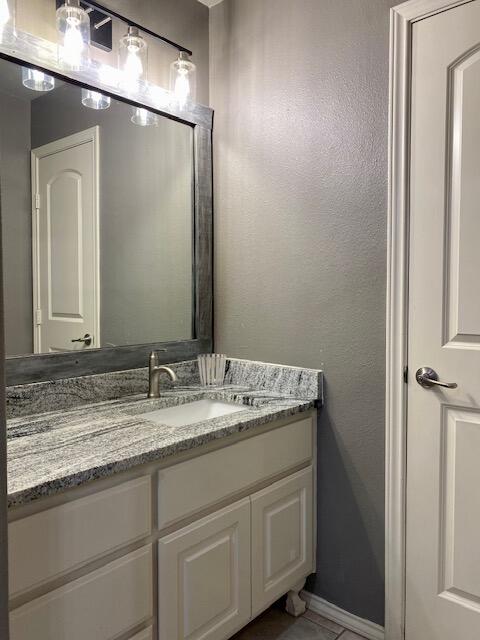 4028 125th Street Lubbock, TX 79423 - Photo 42 of 44 a bathroom with a granite countertop sink and a mirror