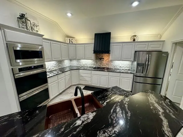 a kitchen with a sink stainless steel appliances and cabinets