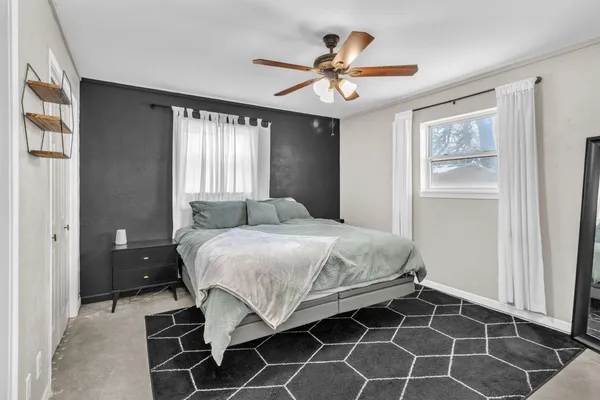 a bedroom with a bed and a window