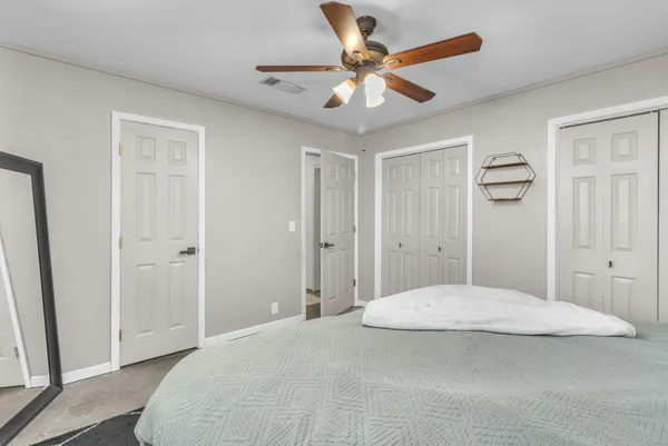 a bedroom with a bed and a chandelier