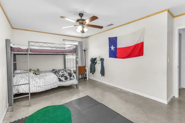 a bedroom with bed and ceiling fan
