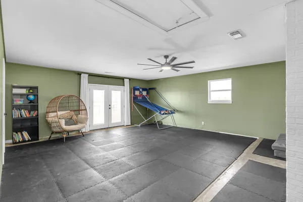 a view of a livingroom with furniture and a chandelier fan