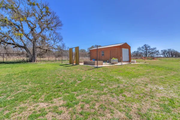 a view of a big yard with large trees