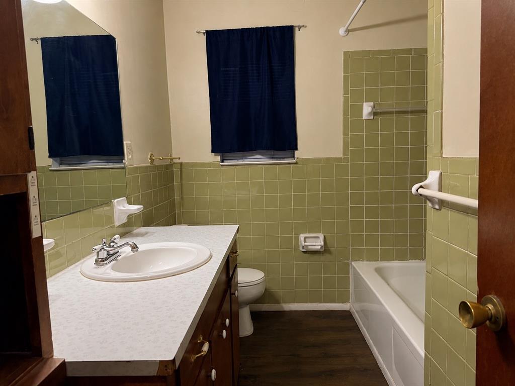 2111 Quail Run, Unit A McKinney, TX 75071 - Photo 8 of 12 a bathroom with a sink a toilet and shower
