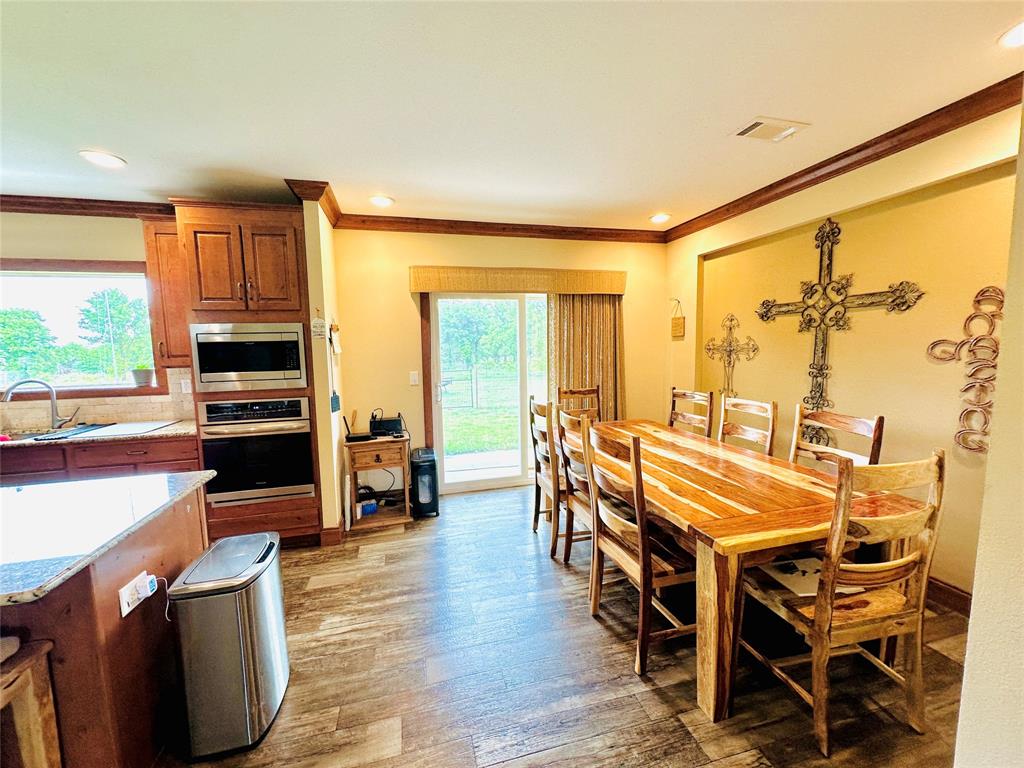 251 County Road 225 Rising Star, TX 76471 - Photo 14 of 40 a dining room with furniture window and wooden floor