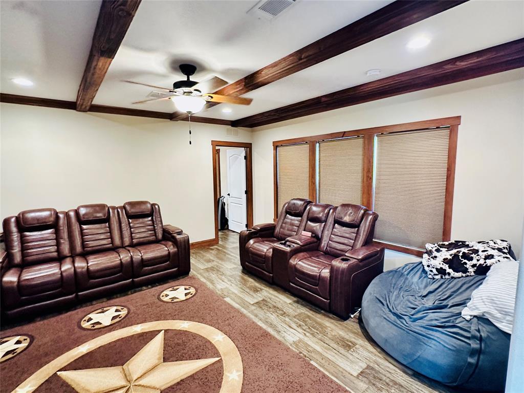 251 County Road 225 Rising Star, TX 76471 - Photo 17 of 40 a living room with furniture ceiling fan and a rug