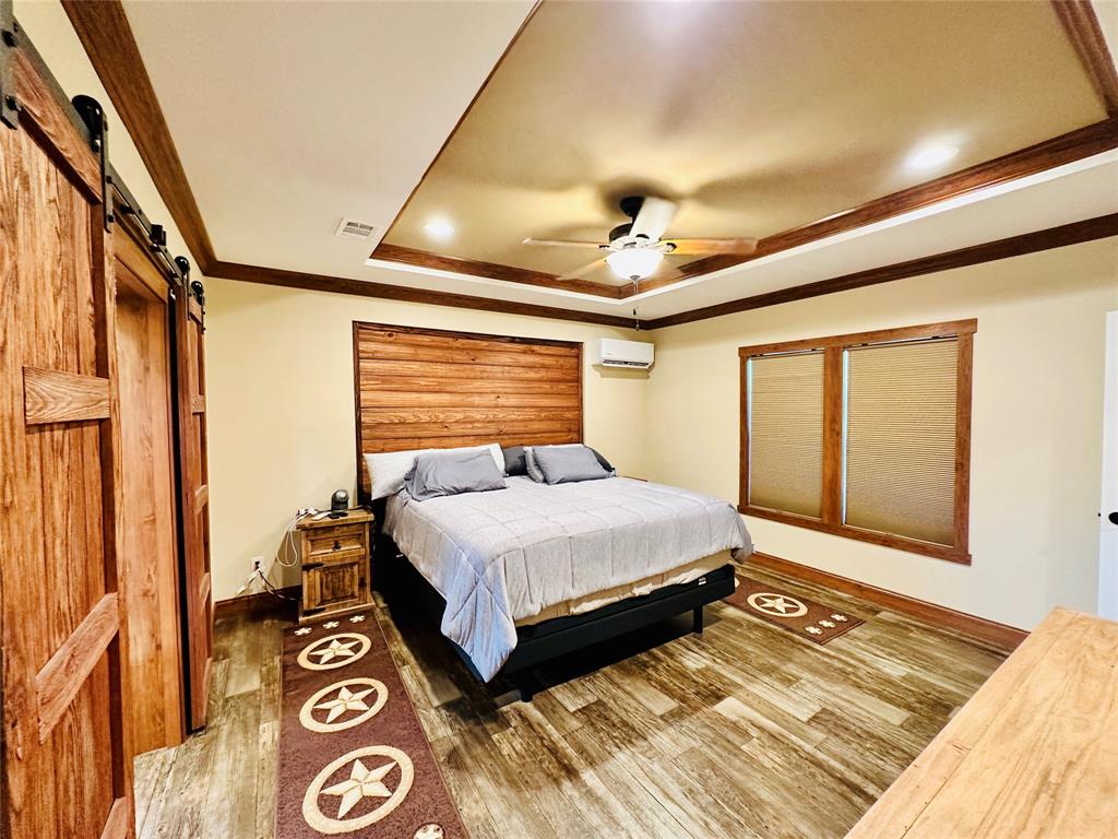 251 County Road 225 Rising Star, TX 76471 - Photo 18 of 40 a spacious bedroom with a bed and a window