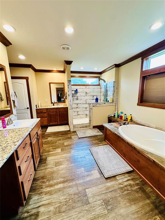 251 County Road 225 Rising Star, TX 76471 - Photo 20 of 40 a living room with stainless steel appliances kitchen island granite countertop a sink and wooden floor