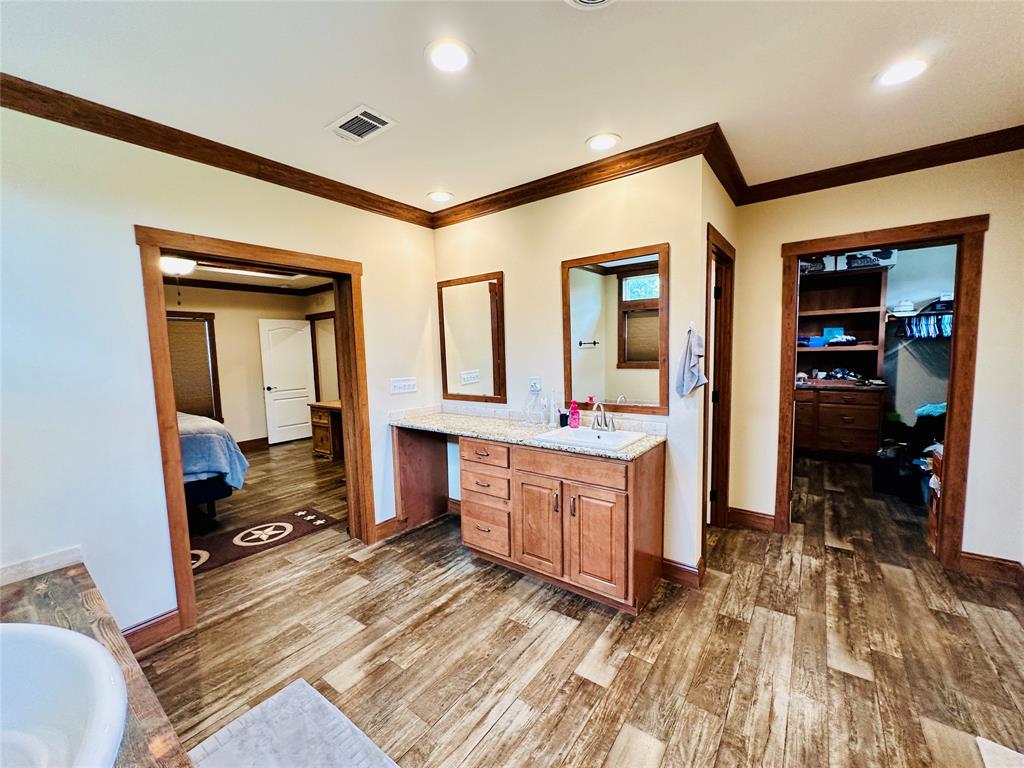 251 County Road 225 Rising Star, TX 76471 - Photo 21 of 40 a spacious bathroom with a double vanity sink and a mirror