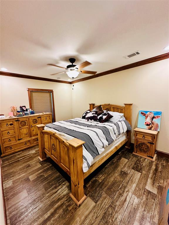 251 County Road 225 Rising Star, TX 76471 - Photo 23 of 40 a bedroom with a bed and wooden floor
