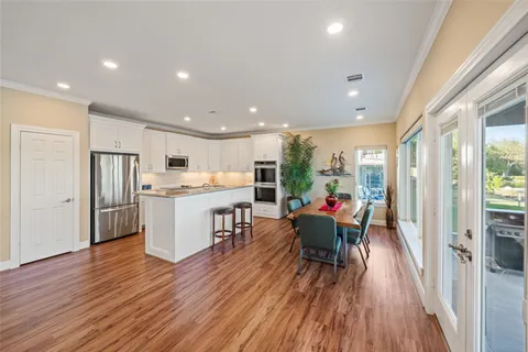 a kitchen with stainless steel appliances granite countertop sink stove and wooden floor