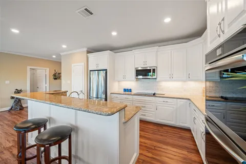 a bathroom with a granite countertop toilet sink and mirror
