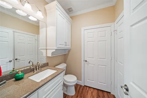 a bedroom with a bed and painting on the wall