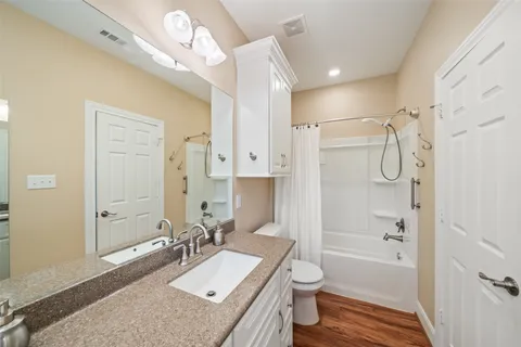 a bedroom with furniture and a flat screen tv