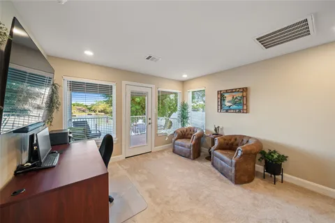 a living room with furniture and a floor to ceiling window