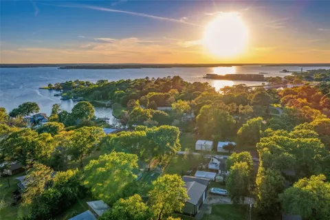 an aerial view of a houses with a lake view