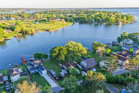 an aerial view of a houses with a lake view