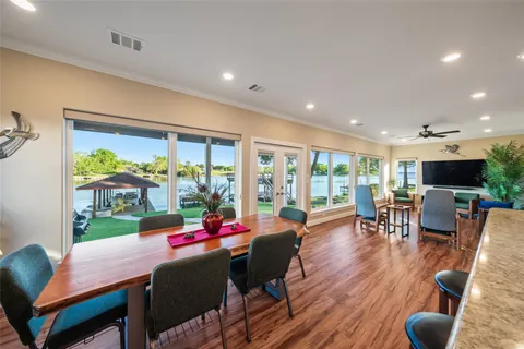a living room with stainless steel appliances furniture and wooden floor